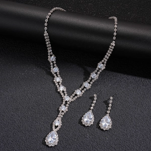 Elegant silver-toned necklace and earrings jewelry set featuring teardrop crystal pendants