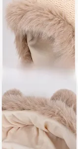 Detail of warm winter knit hat with soft fleece lining and fluffy faux fur trim