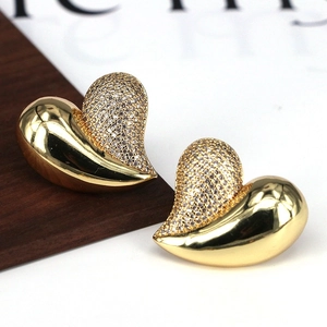 Elegant gold heart stud earrings featuring a half-pavé zircon setting and polished finish