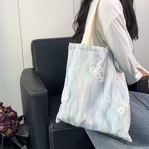 Grand sac cabas en toile marbrée bleue avec broderies florales en dentelle sur l'épaule