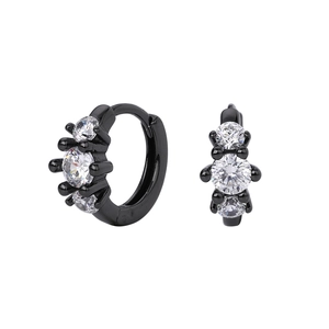Detail view of black sterling silver hoop earrings with three white zircon stones