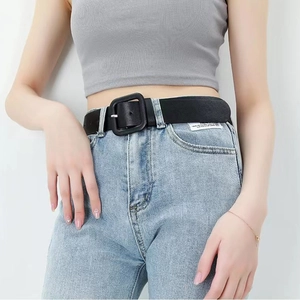Women's black faux leather waist belt with matte square buckle on denim jeans