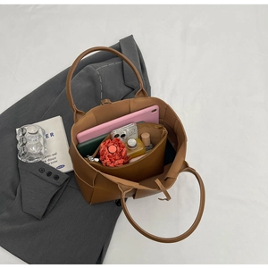 Brown woven tote bag showing spacious interior with tablet, umbrella, and inner pouch