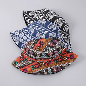 Detailed view of stacked bucket hats with elephant prints and ethnic geometric patterns
