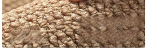 Macro shot of faux sisal rug fiber detail showing durable loop pile weave texture