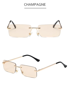 Detail of champagne rimless rectangular sunglasses with gold metal frame and black tips