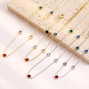Gold and silver multi-color gemstone tennis bracelets on stone props, minimalist design