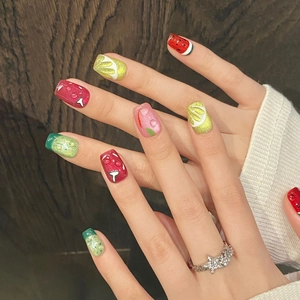 Colorful fruit party press-on nails with 3D water drops and glitter on wood background