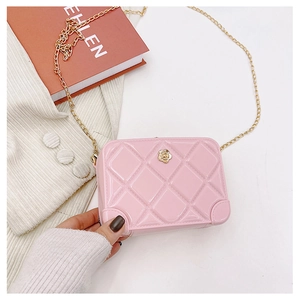 Detailed close-up of pink PVC quilted mini bag with golden flower clasp and chain