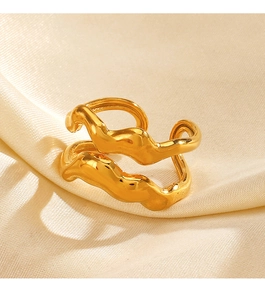 Detailed close-up of double-layered wavy golden stainless steel ring on silk fabric