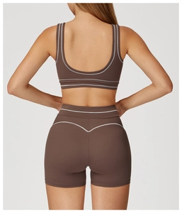 Rear view of brown yoga bra and shorts with white contrast trim and U-shaped back detail