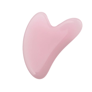 Pink heart-shaped resin facial massage tool with smooth edges for skin care