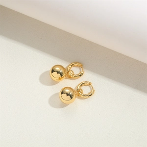 Close-up of 14K gold plated French vintage hoop earrings with textured gold ball charms