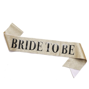 Detail of rose gold glitter sash with black Bride To Be lettering for bachelorette party