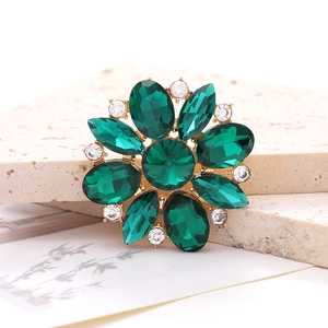 Detailed macro view of green horse-eye crystal flower accessory with gold alloy base