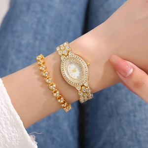 Women's gold quartz watch and heart bracelet set with sparkling crystal details on wrist