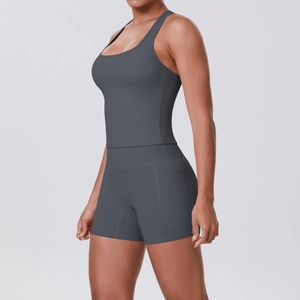 Detail of dark grey sports set featuring racerback tank top and shorts with side pocket