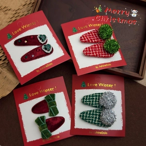 Close-up of velvet and plaid Christmas hair clips with heart gems and ribbons