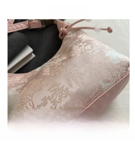 Detail of pink jacquard fabric bag with traditional Chinese mountain landscape pattern