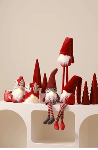 Close-up of five festive Christmas gnomes with warm LED lights on a white display stand