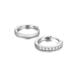 Macro shot of S925 silver wave hoop earrings with one polished and one diamond-set band