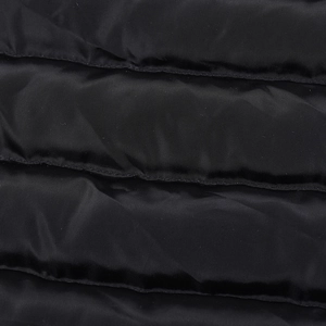 Macro shot of black quilted fabric showing fine texture and subtle synthetic gloss finish