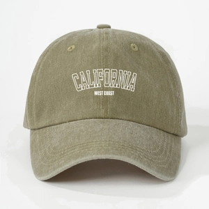 Detailed macro view of embroidered CALIFORNIA text on washed cotton baseball cap fabric