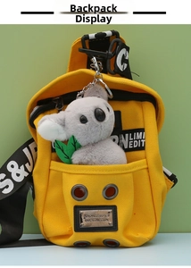 Close-up of bright yellow canvas mini backpack with cute plush koala keychain detail