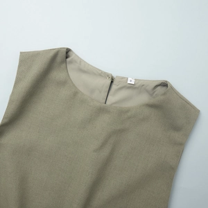 Detail of round neckline and fabric texture on olive green sleeveless cotton linen top