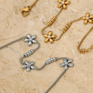 Sweet flower beaded box chain bracelet in gold and silver finish with zircon accents