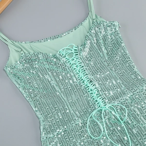 Detail of mint green sequin dress showing lace-up back design and shimmering texture