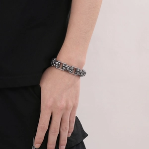 Close-up of a men's vintage skull biker chain bracelet in silver stainless steel on wrist