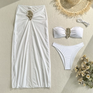 Detailed view of white three-piece bikini set with metallic shell buckles and mesh cover-up