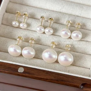 Five pairs of round white pearl stud earrings in various sizes with golden metal pins