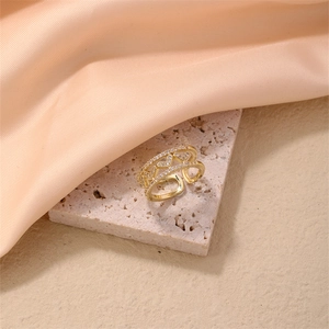 Detail of adjustable gold double-layer heart ring with sparkling pavé-set zircons