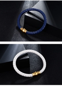 Detail view of navy blue and white braided leather bracelets with gold magnetic clasps