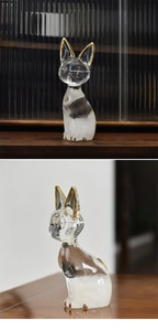 Macro detail of cat-shaped glass storm bottle with gold-painted accents and transparent finish