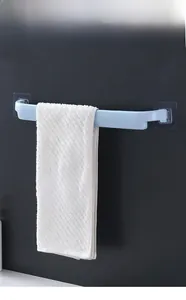 Detail showing a blue wall-mounted towel rack holding a white towel in a modern bathroom