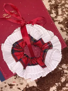 Detail of red plaid and white lace hair scrunchie with a silk ribbon bow decoration