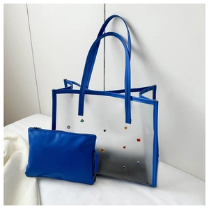 Close-up of blue transparent PVC tote bag with colorful crystals and matching inner pouch