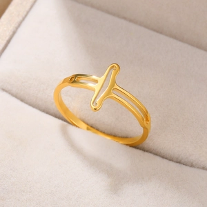 Detailed view of an 18k gold plated stainless steel ring with a geometric cross design