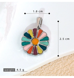 Macro shot of colorful enamel sunflower pendant with detailed size labels and weight info