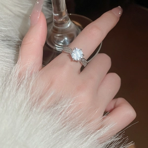 Close-up of a rotating snowflake zircon ring on finger with elegant silver finish