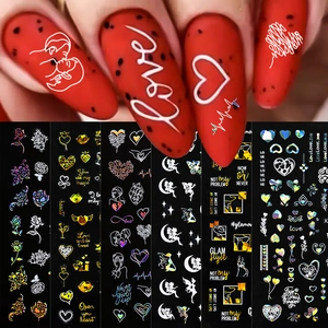 Detail view of 3D laser holographic nail stickers featuring red hearts and roses