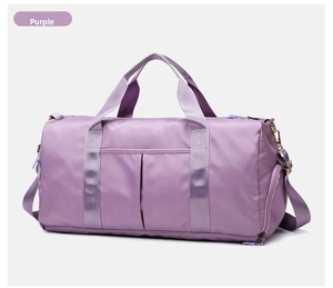 Detail of purple waterproof travel bag showing dual handles and independent shoe compartment