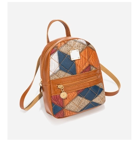 Detail of colorful patchwork backpack with orange and blue diamond leather patterns
