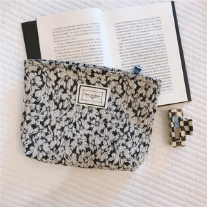 Floral textured makeup bag with Time to Party patch and zipper closure detail
