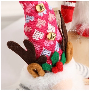 Detailed view of Christmas gnome showing knitted fabric textures and metal bell decor