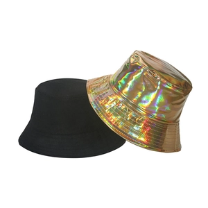 Detail of metallic laser gold bucket hat next to a classic black streetwear sun cap
