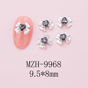 Detail of silver alloy bow nail charm with black heart zircon, size 9.5x8mm on nail